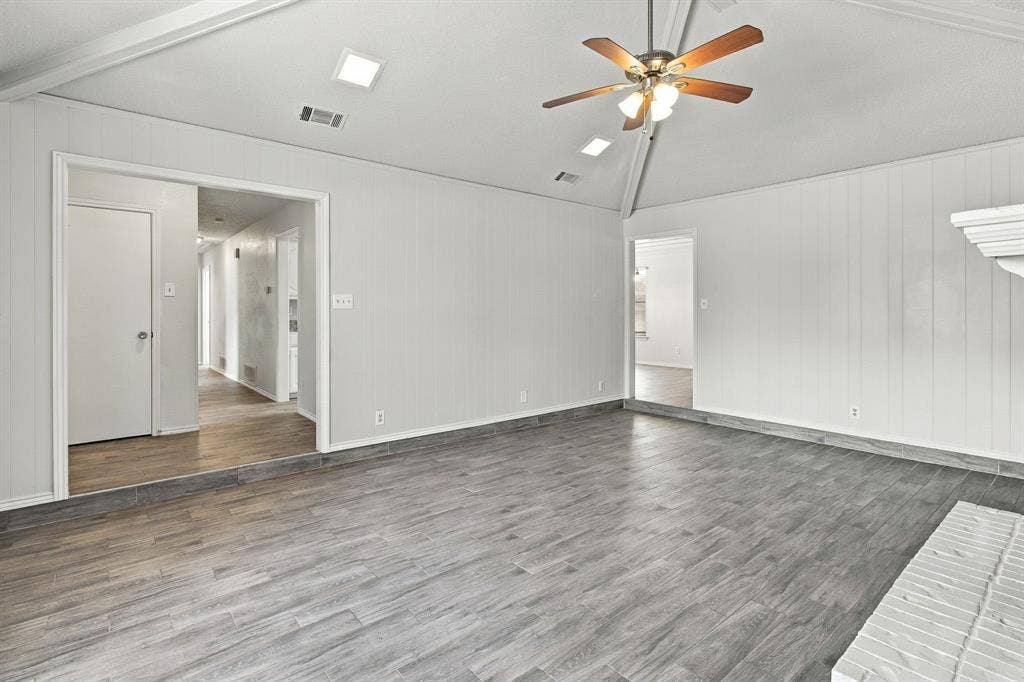 438 Blueridge Drive, Duncanville, TX 75137 Vaulted ceiling featuring recessed lighting and a central ceiling fan, plank-style flooring, and vertical panel wall detailing