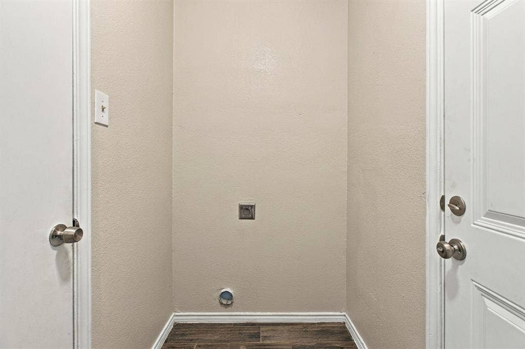 438 Blueridge Drive, Duncanville, TX 75137 Dedicated utility alcove featuring wood-finish flooring, textured walls, and integrated plumbing connections