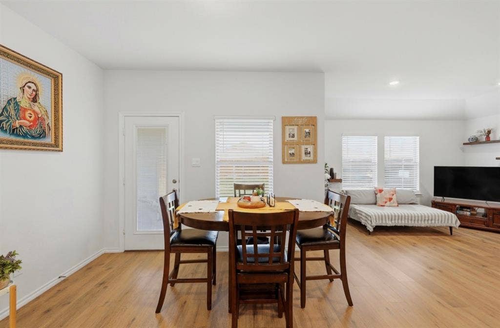 6535 Sand Dune Way, Princeton, TX 75407 Open-concept room featuring wood-finish flooring, recessed lighting, white walls, and glass-paneled exterior door