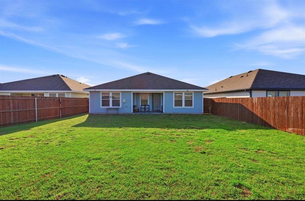 6535 Sand Dune Way, Princeton, TX 75407 Expansive backyard featuring a large grass lawn and wood privacy fencing