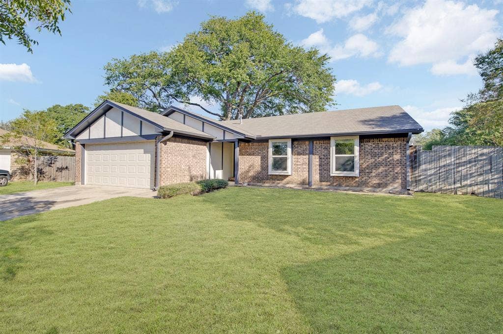912 Shell Court, Bedford, TX 76022 Brick exterior with light-colored trim and a prominent garage door