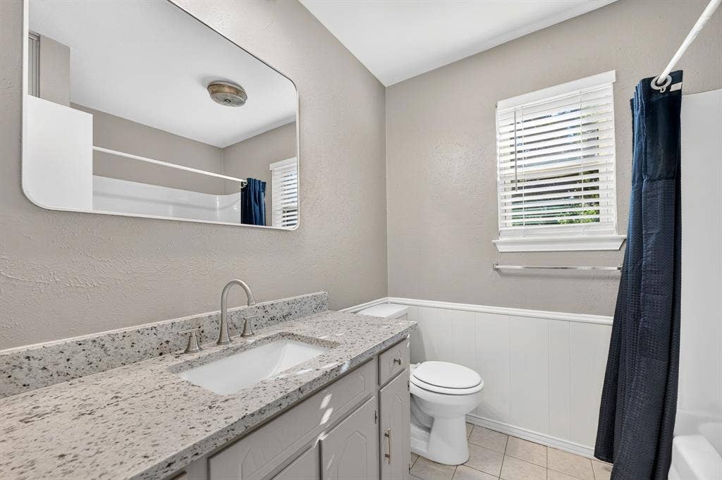 912 Shell Court, Bedford, TX 76022 Vanity with a light-toned countertop, undermount sink, and brushed nickel faucet
