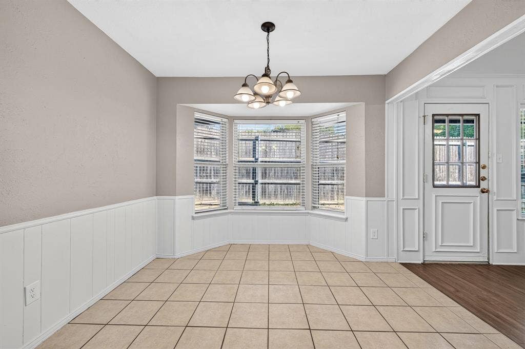 912 Shell Court, Bedford, TX 76022 Bay window with blinds, tile flooring, recessed lighting, and wainscoting
