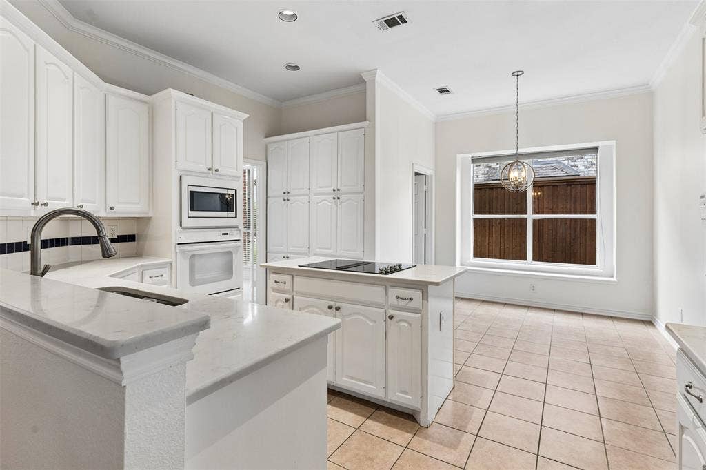 327 Hampton Court, Coppell, TX 75019 Kitchen featuring white cabinetry, stone-finish countertops, a center island with a built-in cooktop, integrated wall oven and microwave, and tile flooring