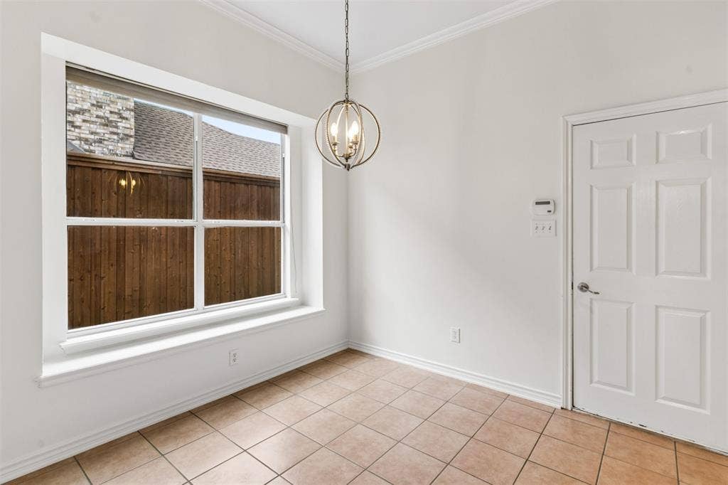 327 Hampton Court, Coppell, TX 75019 Large window featuring a deep sill, spherical metal-frame chandelier, neutral tile flooring, and a six-panel interior door