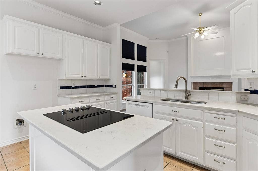 327 Hampton Court, Coppell, TX 75019 Kitchen featuring white shaker-style cabinetry, quartz countertops, a central island with an integrated induction cooktop, and tile flooring