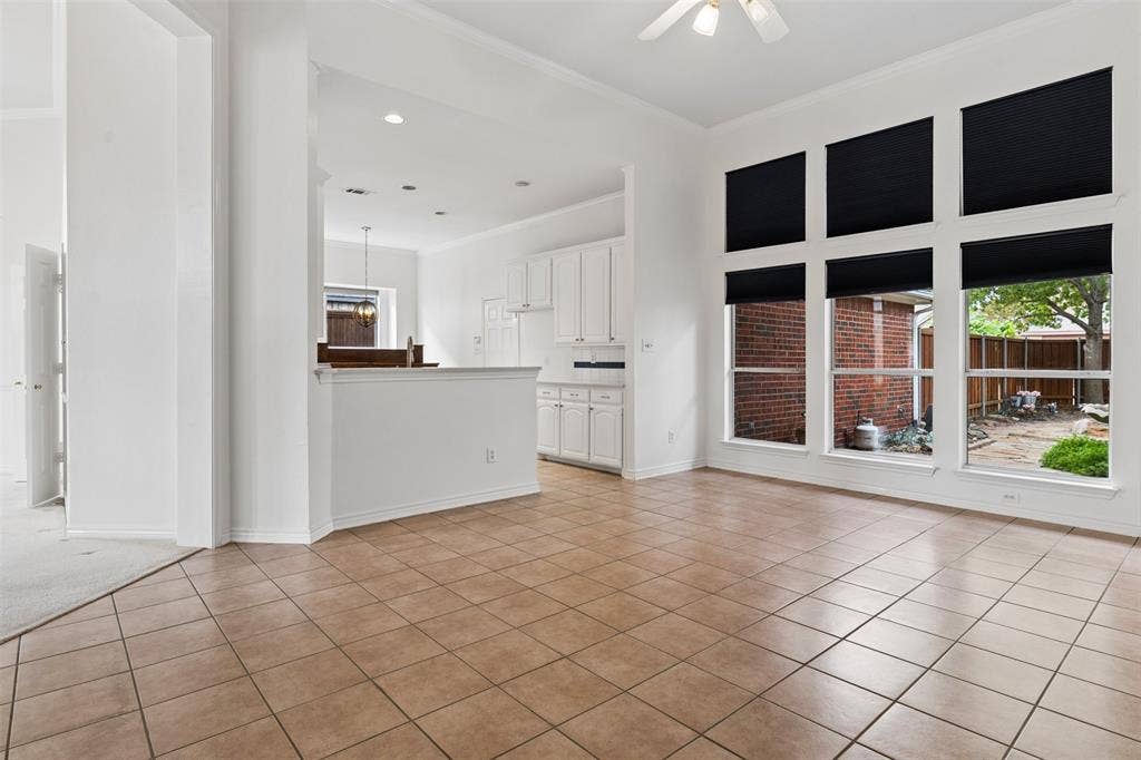 327 Hampton Court, Coppell, TX 75019 Open-concept room featuring tile flooring, high ceilings, large windows with black shades, and built-in cabinetry
