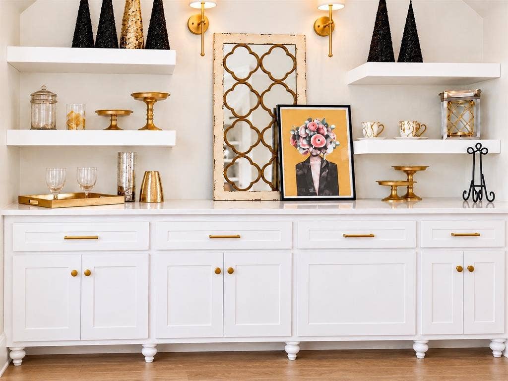 6651 Pinehurst Drive, Granbury, TX 76049 Built-in white cabinetry with gold-tone hardware, floating shelves, and a light-toned countertop
