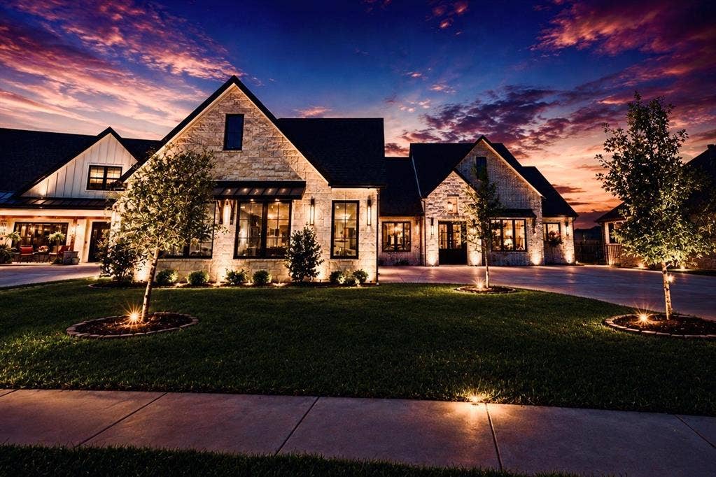 6651 Pinehurst Drive, Granbury, TX 76049 Stone exterior with dark trim windows, multi-gabled roofline, and established landscaping