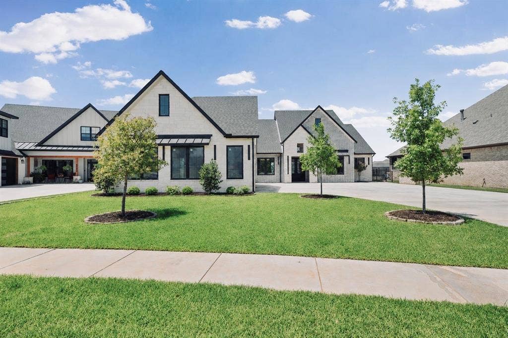 6651 Pinehurst Drive, Granbury, TX 76049 Contemporary farmhouse-style exterior featuring a white brick facade, black-framed windows, and a covered front entry