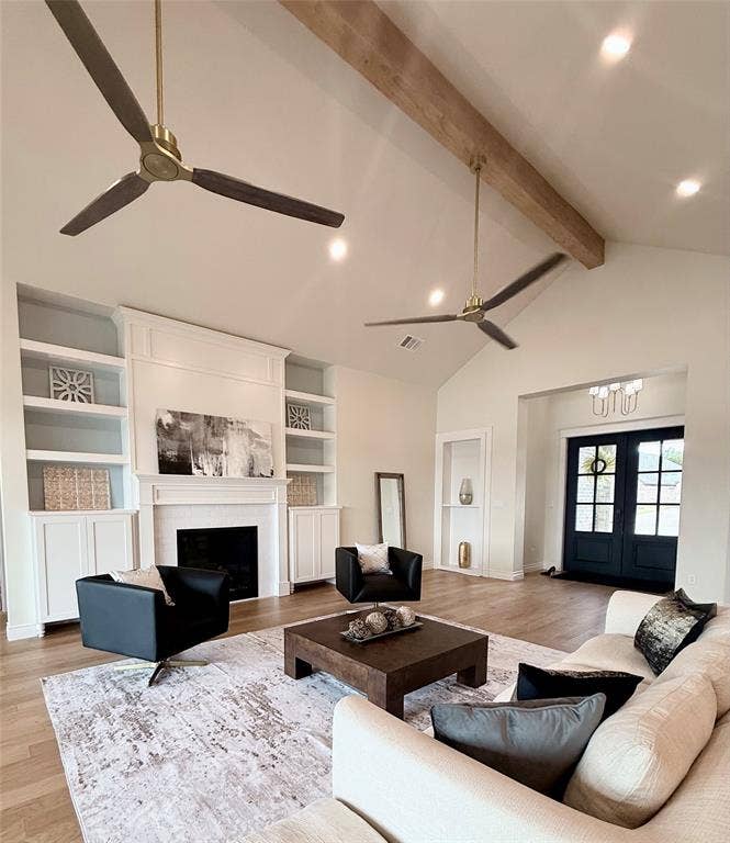 6651 Pinehurst Drive, Granbury, TX 76049 Vaulted ceiling with exposed wood beam, recessed lighting, hardwood flooring, built-in shelving, and a prominent fireplace with a mantel