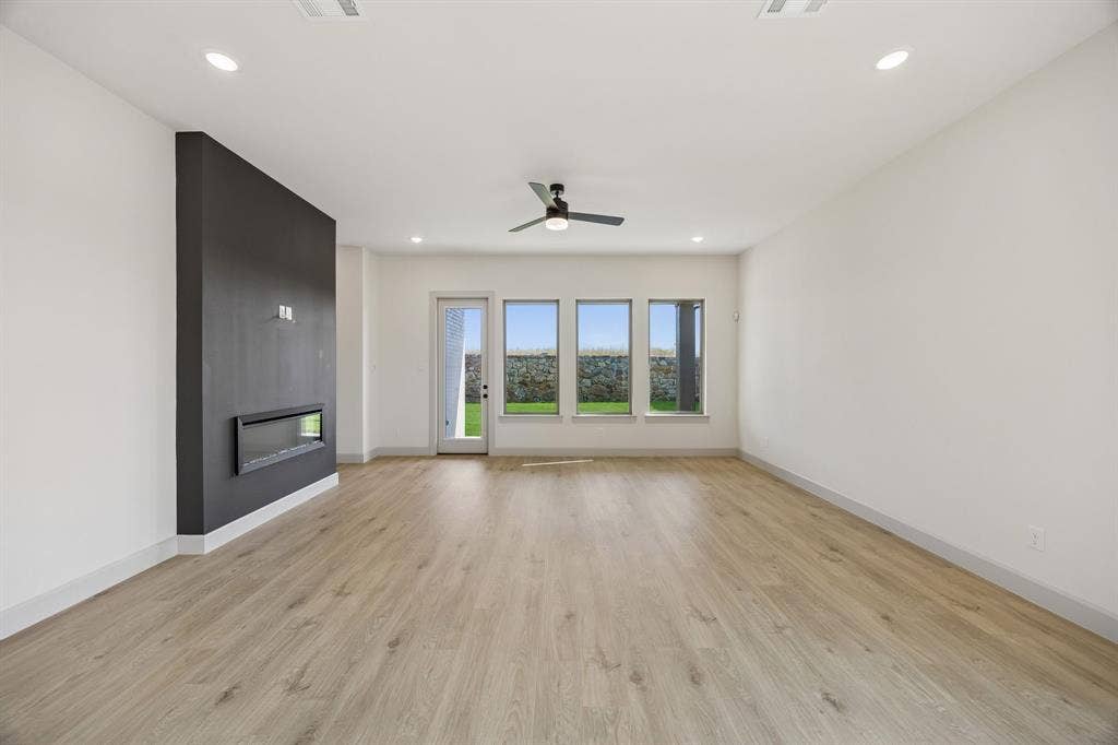 2444 Aurora Avenue, Celina, TX 75009 Memories are waiting to be made in this spacious family room featuring a striking fireplace wall!