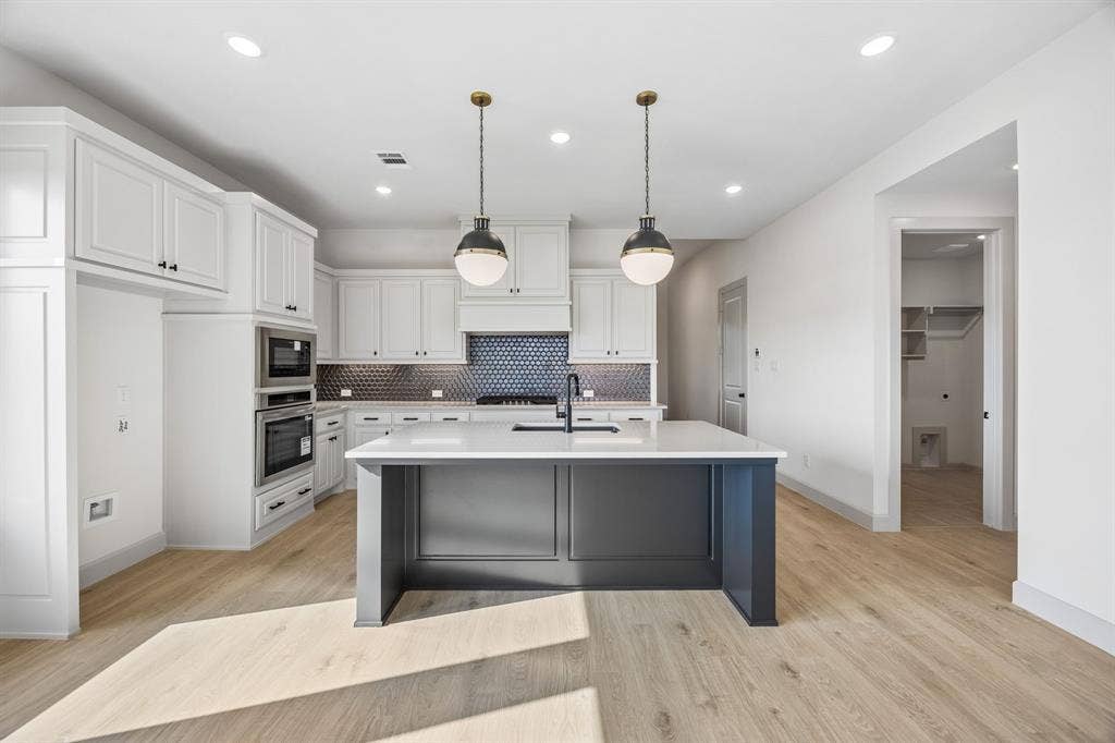 2444 Aurora Avenue, Celina, TX 75009 Featuring beautiful cabinetry, gorgeous counter tops, designer backsplash and high end appliances, this dream kitchen offers something for every member of the family!