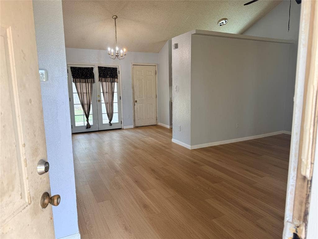 1644 Taylorcrest Drive, Dallas, TX 75253 Wood-finish flooring throughout, vaulted ceiling, and a chandelier lighting fixture
