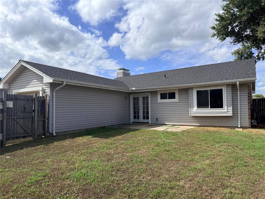 1644 Taylorcrest Drive, Dallas, TX 75253 Exterior featuring light gray siding, dark shingle roofing, a bay window, and a patio with French doors