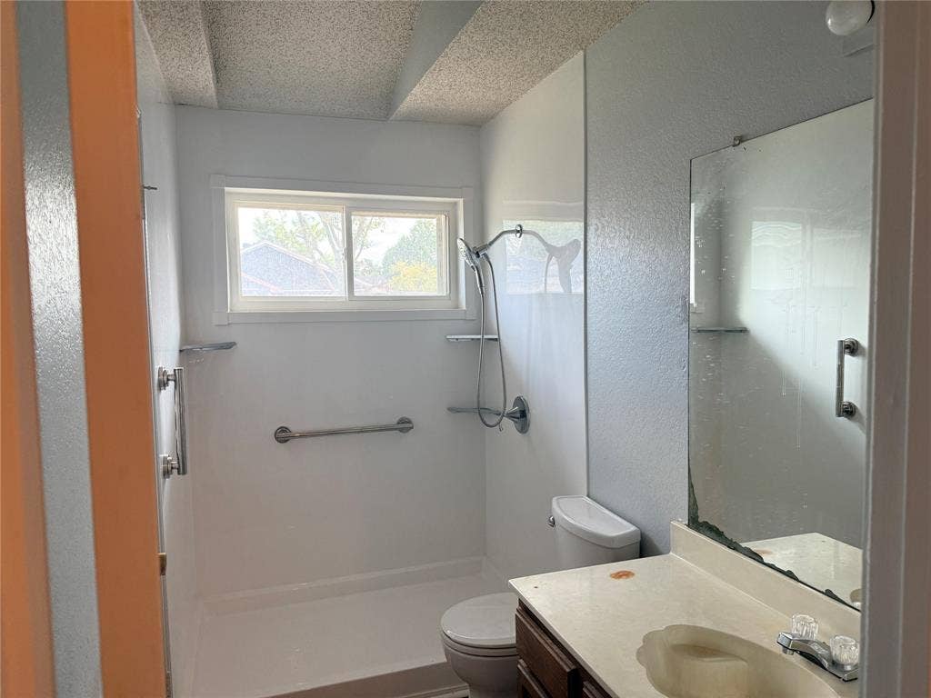 1644 Taylorcrest Drive, Dallas, TX 75253 Shower with chrome fixtures, window, and grab bars