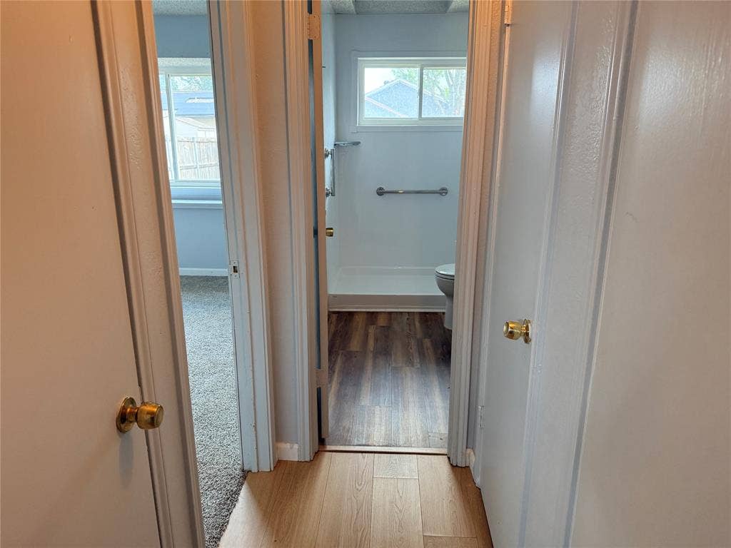 1644 Taylorcrest Drive, Dallas, TX 75253 Wood-finish flooring in hallway with brass door hardware