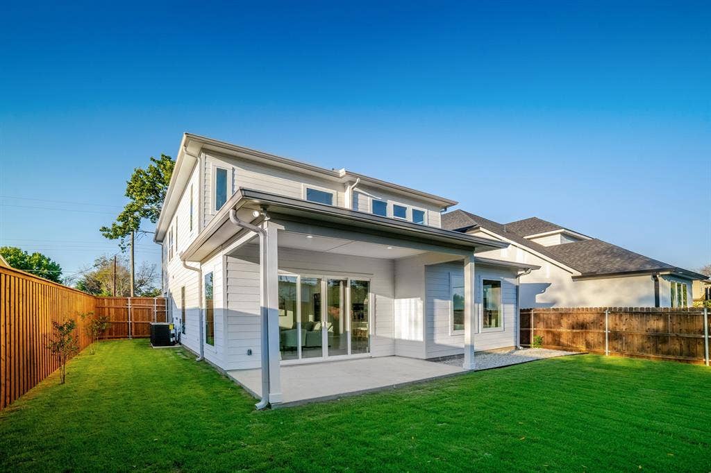 Rear exterior featuring a covered patio, horizontal lap siding, and sliding glass doors