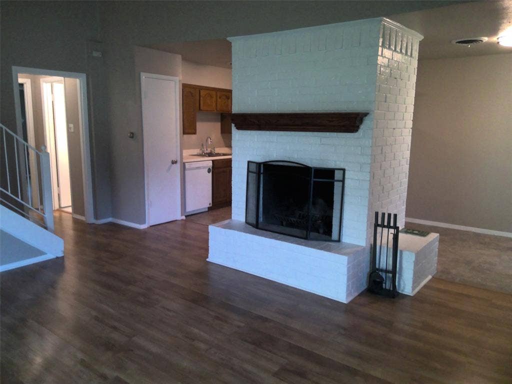 7348 Walling Lane, Dallas, TX 75231 Fireplace faces the den and separates the breakfast and kitchen areas