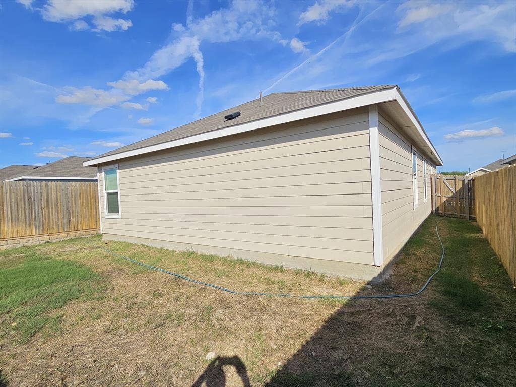 3338 Beckwith Way, Crandall, TX 75114 Exterior featuring horizontal siding, a fenced perimeter, and a pitched shingle roof