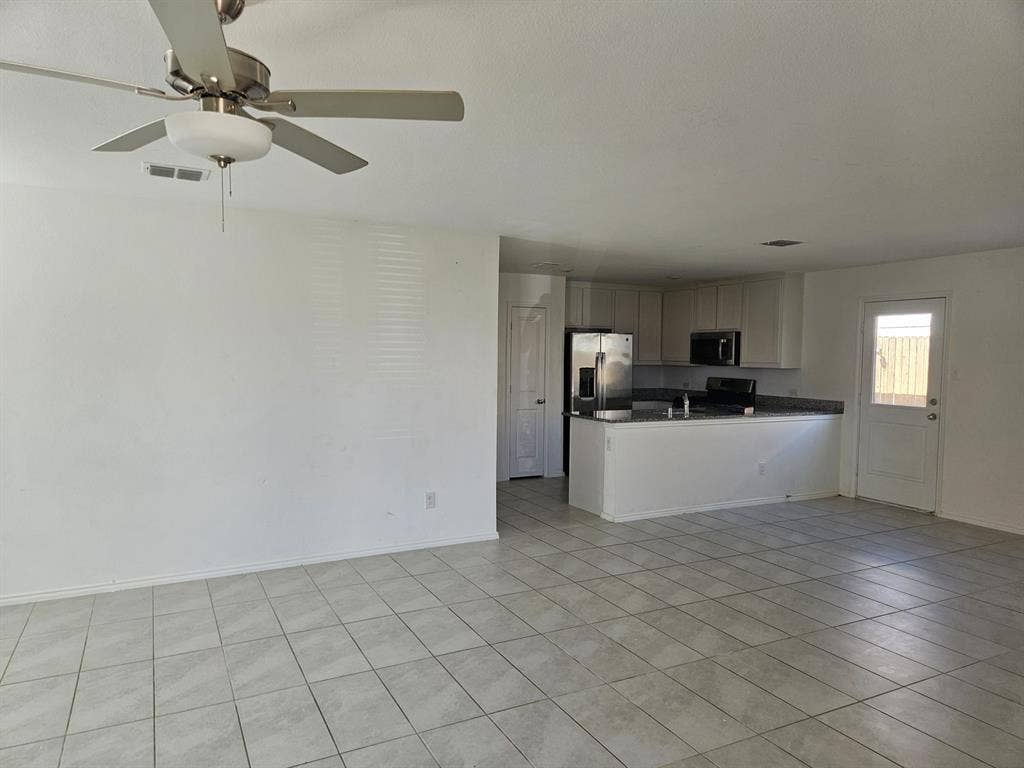 3338 Beckwith Way, Crandall, TX 75114 Open-concept living space with tile flooring, stainless steel appliances, and a ceiling fan