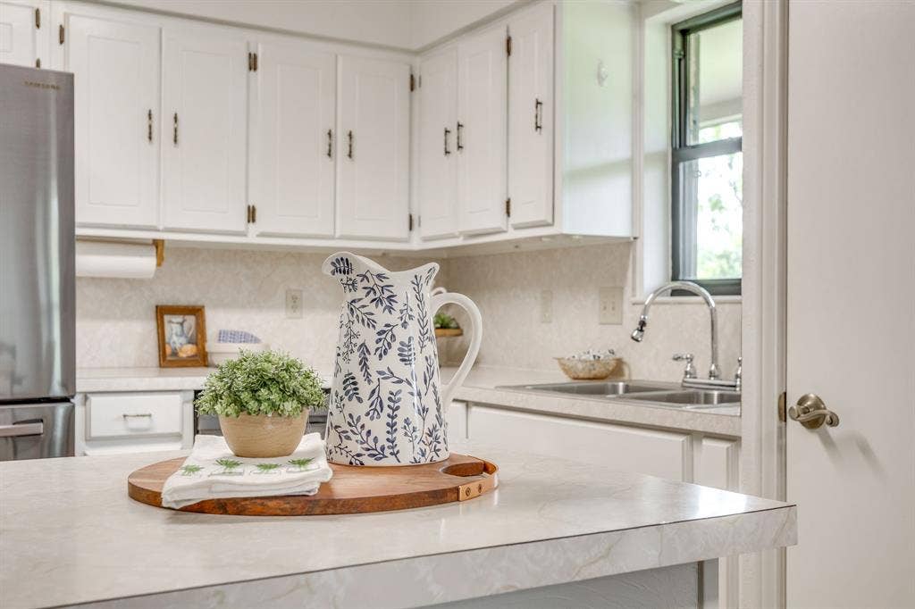 White upper cabinetry with dark hardware