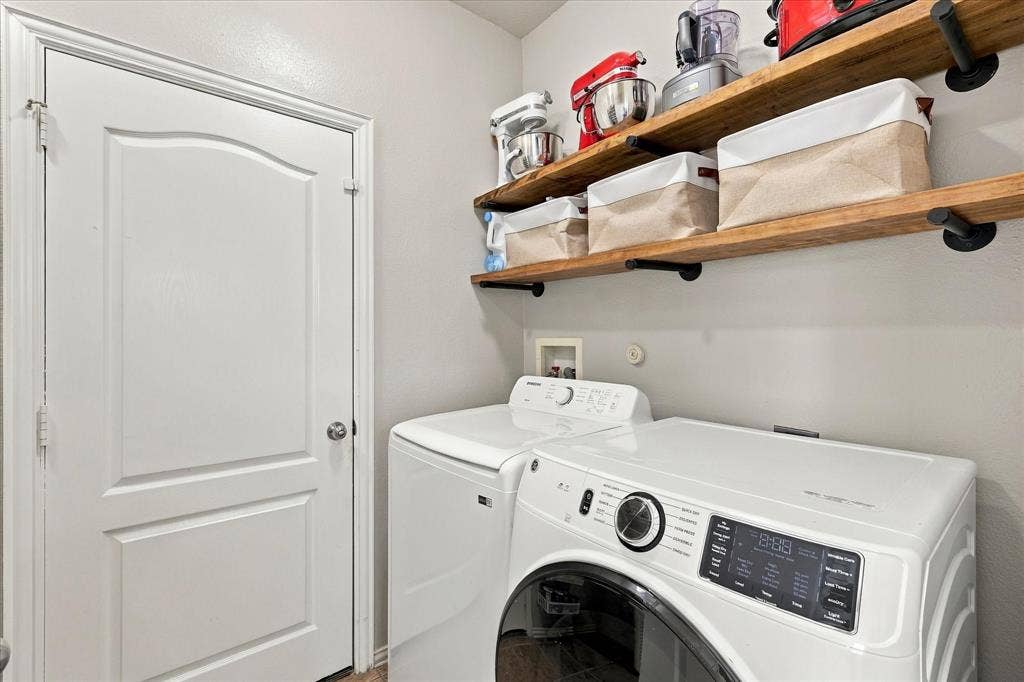 Wood-finish floating shelves on black supports provide convenient storage