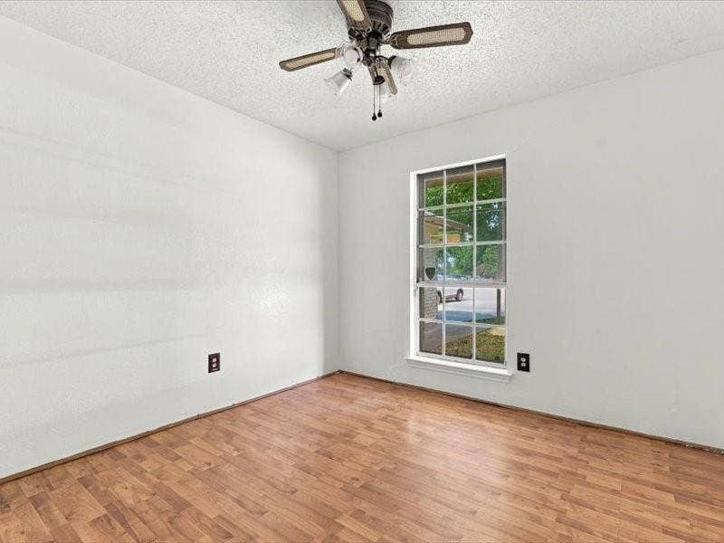 725 Southridge Court, Grand Prairie, TX 75052 Wood-finish flooring, single window, textured ceiling, and a ceiling fan with light fixture