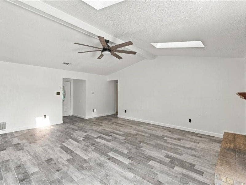 725 Southridge Court, Grand Prairie, TX 75052 Vaulted ceiling, wood-finish flooring, ceiling fan, skylight, fireplace