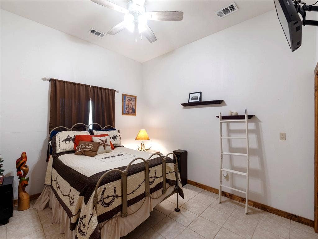 5801 County Road 4128, Scurry, TX 75158 Vaulted ceilings featuring a central multi-blade ceiling fan and neutral tile flooring complemented by wood-finish trim