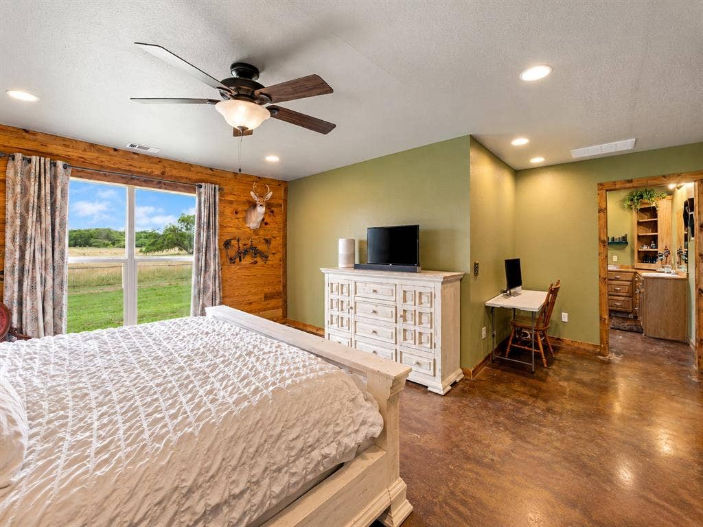 5801 County Road 4128, Scurry, TX 75158 Expansive window, recessed lighting, ceiling fan, wood-finish flooring, and a natural wood-trimmed doorway