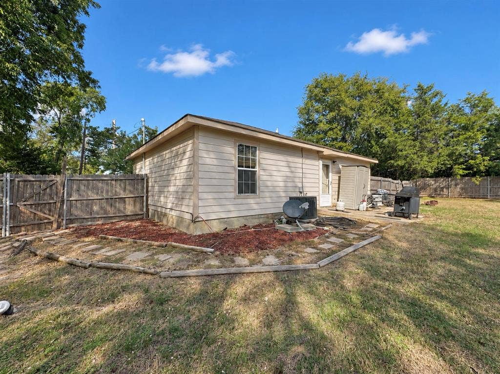208 Olive Street, Lone Oak, TX 75453 Wood-paneled fencing enclosing the property, featuring a side gate