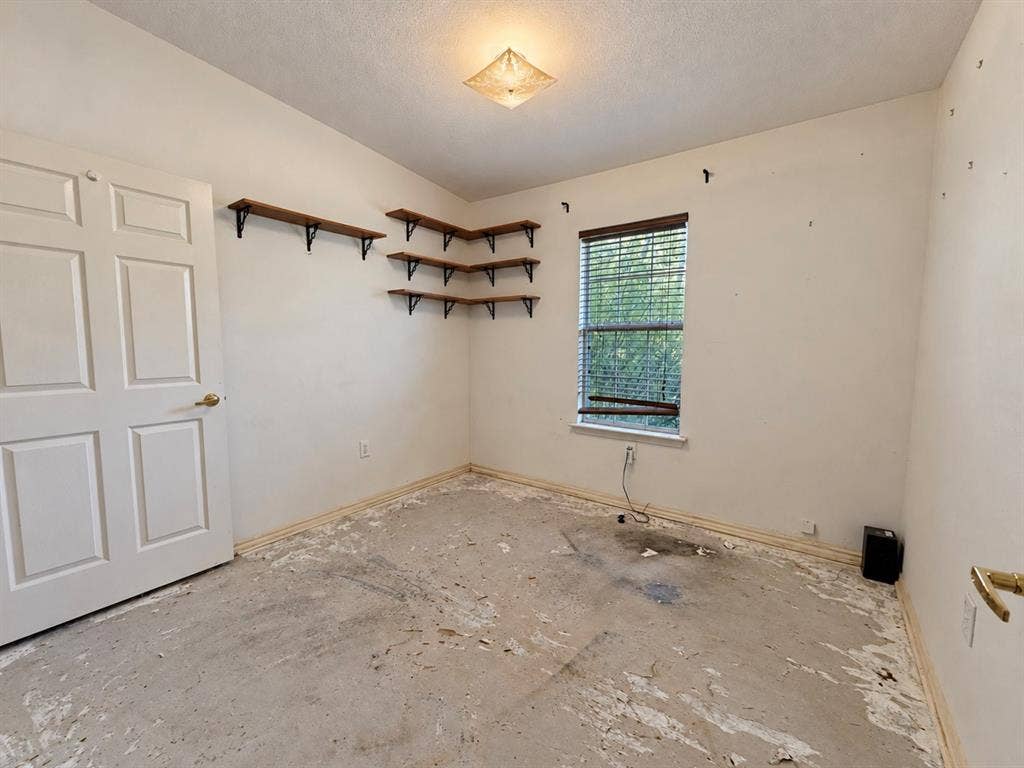 208 Olive Street, Lone Oak, TX 75453 Recessed ceiling light fixture, corner wall shelving with wood-finish shelves, window with blinds