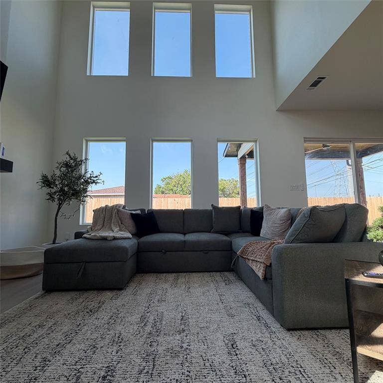 Double-height ceiling featuring tiered windows and wood-finish flooring, 20 ft fireplace