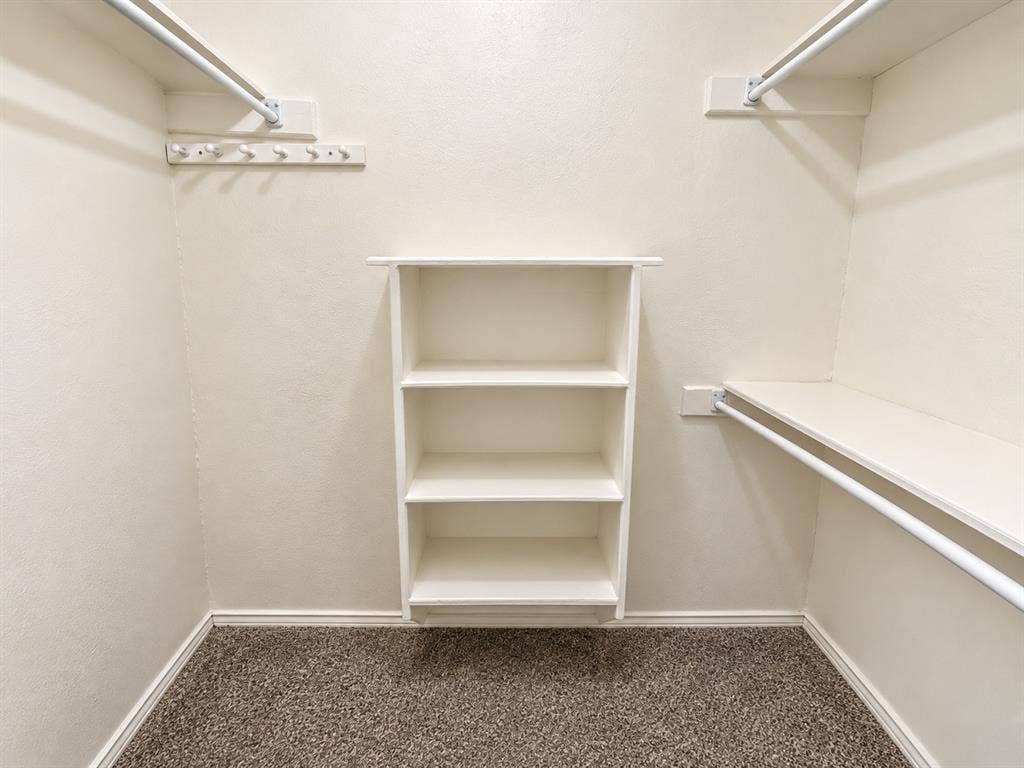 1444 Marlene Place, DeSoto, TX 75115 Built-in shelving, integrated hanging rods, wall-mounted hooks, and carpeted flooring