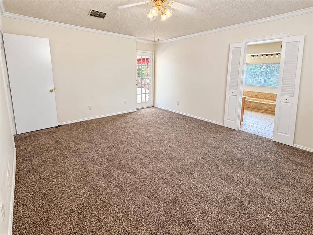 1444 Marlene Place, DeSoto, TX 75115 Brown pile carpeting, white walls, and crown molding