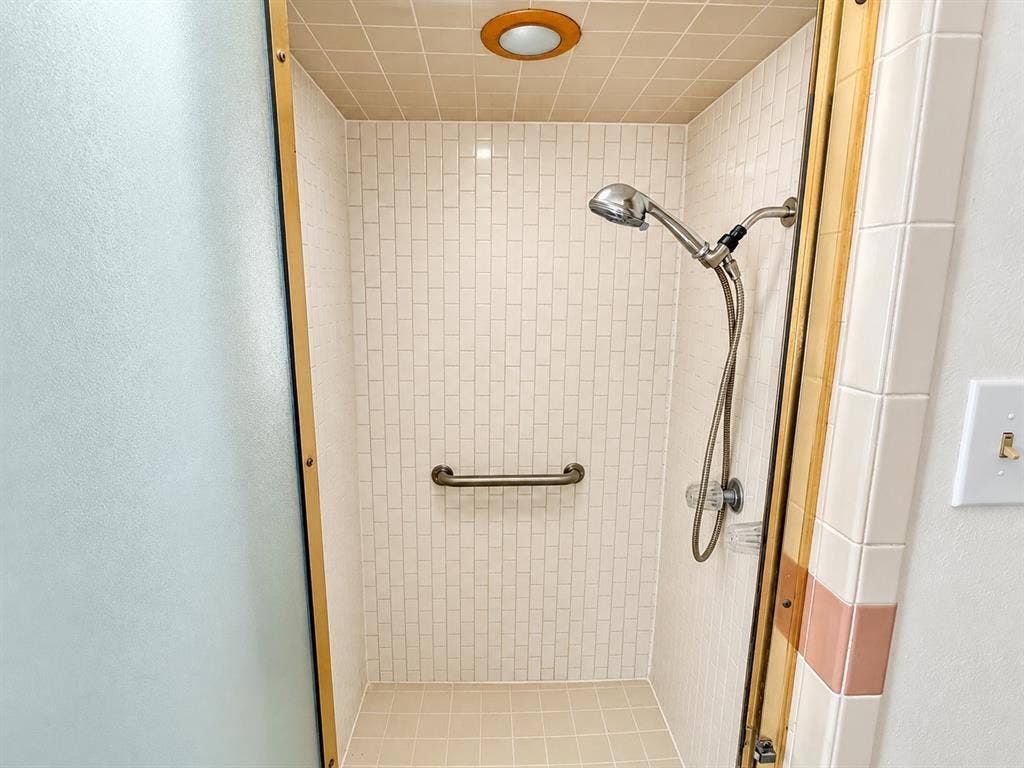 1444 Marlene Place, DeSoto, TX 75115 Walk-in shower with mosaic tile walls, tiled ceiling, and a grab bar