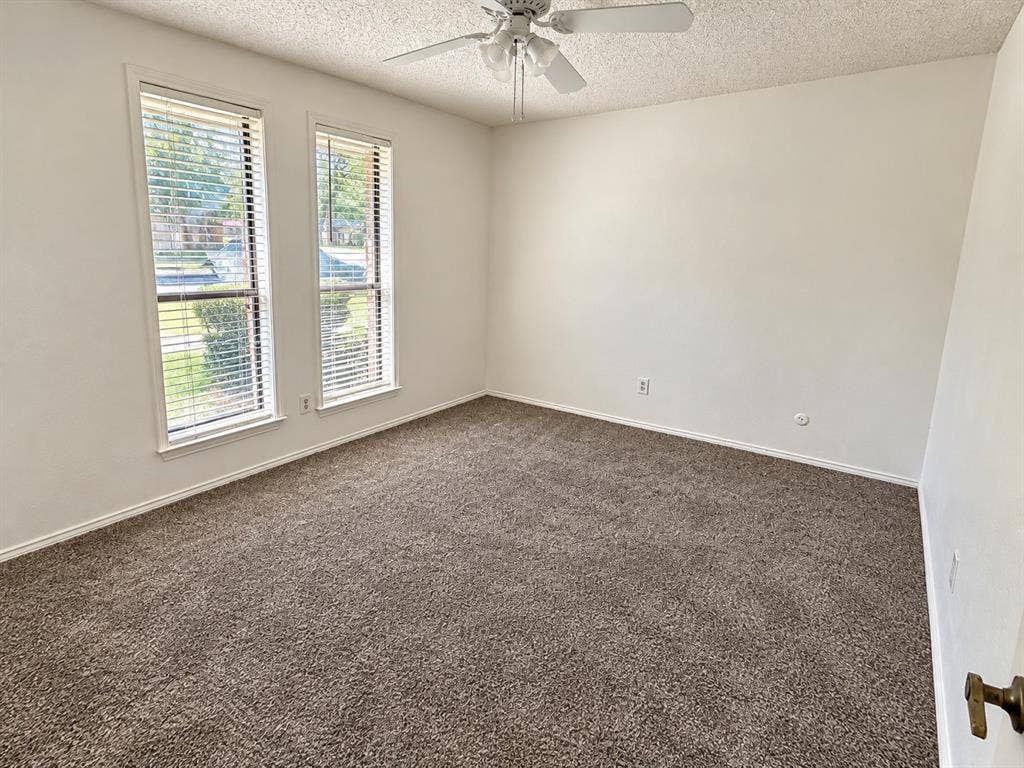 1444 Marlene Place, DeSoto, TX 75115 Neutral-toned walls, brown carpeting, and a ceiling fan