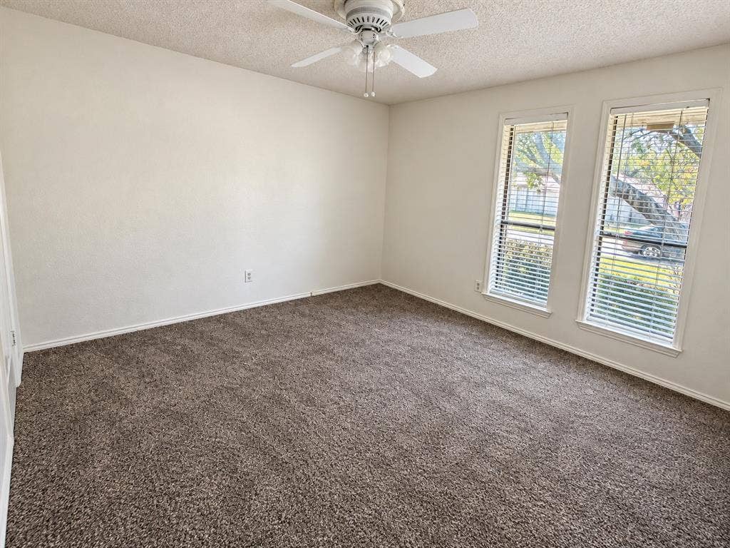 1444 Marlene Place, DeSoto, TX 75115 Neutral wall finishes, textured ceiling, ceiling fan, carpeted flooring, and two windows with blinds