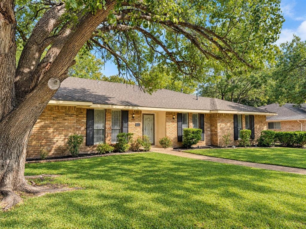 1444 Marlene Place, DeSoto, TX 75115 Brick exterior featuring a gabled roof and dark window shutters