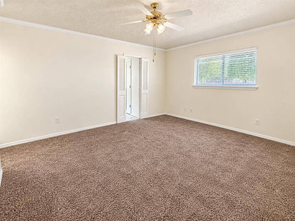 1444 Marlene Place, DeSoto, TX 75115 Neutral-toned carpet flooring, a ceiling fan with integrated lighting, and crown molding