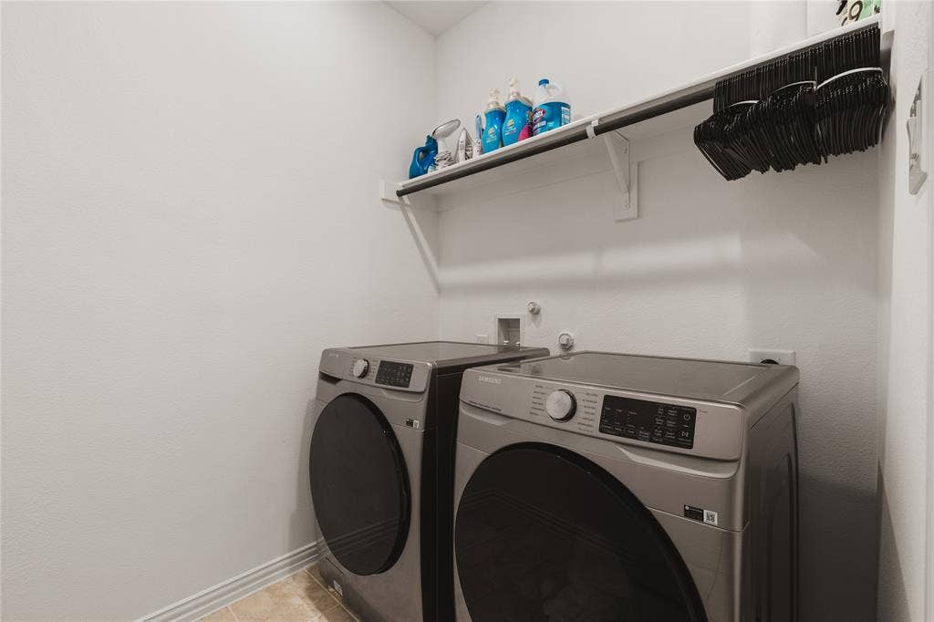 1456 Martingale Lane, Forney, TX 75126 Dedicated utility area featuring a mounted upper storage shelf with integrated hanging rod