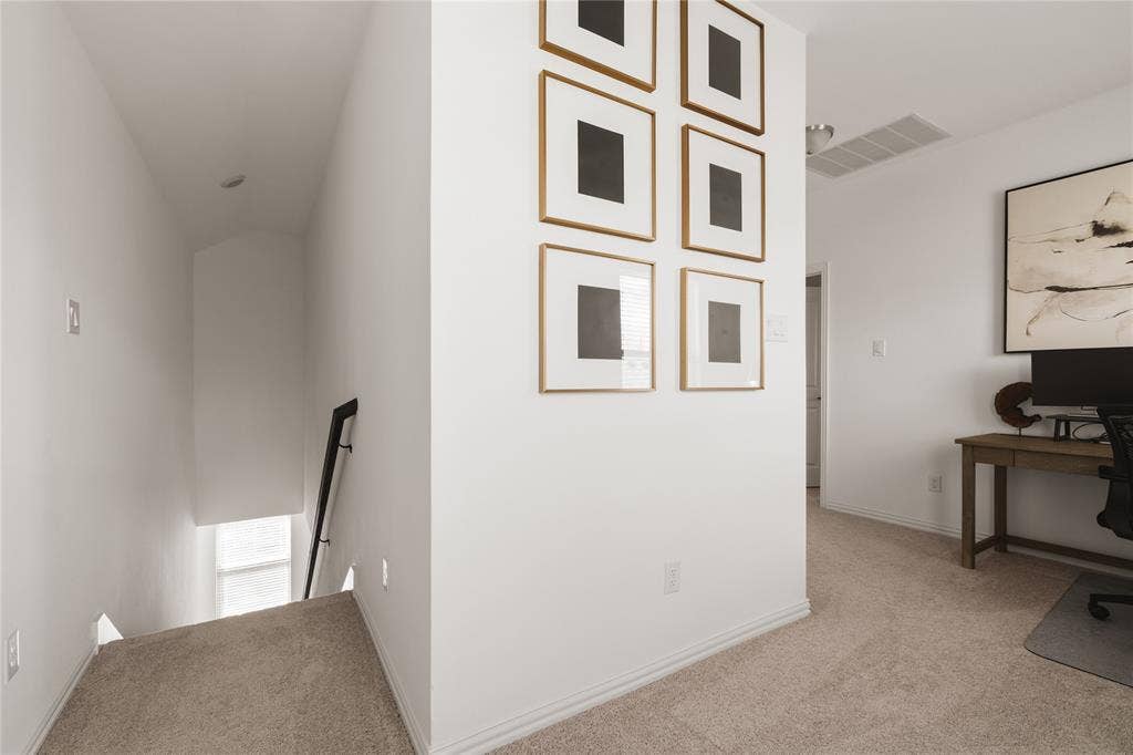 1456 Martingale Lane, Forney, TX 75126 Neutral wall-to-wall carpeting, staircase with black metal handrail, and arched ceiling detail
