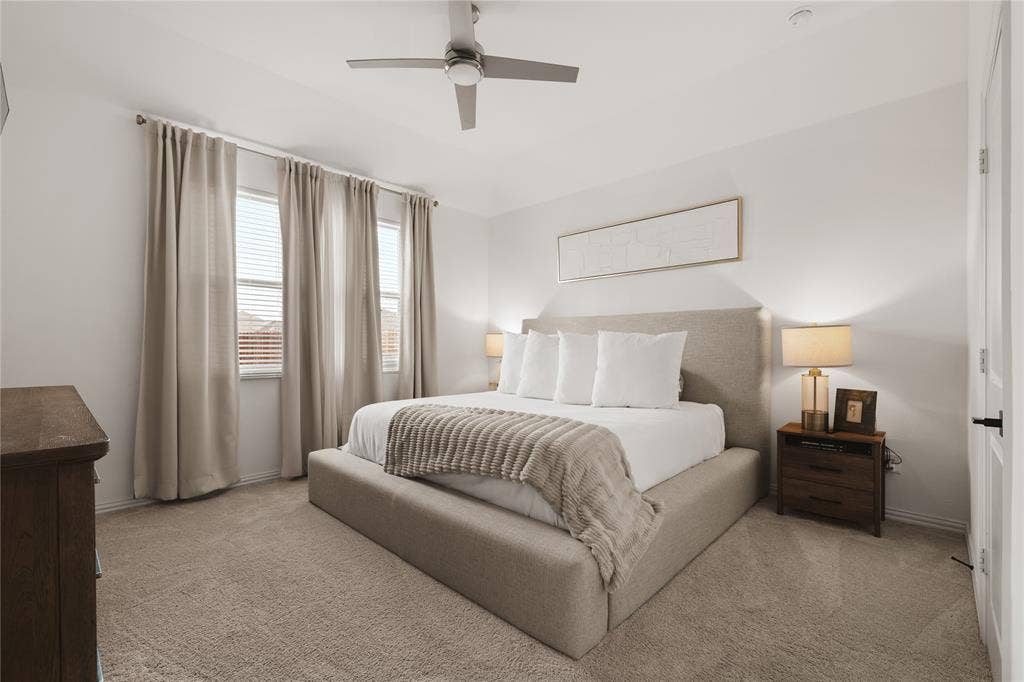 1456 Martingale Lane, Forney, TX 75126 Neutral-toned wall-to-wall carpeting, multi-pane windows, and a brushed metal ceiling fan with integrated lighting