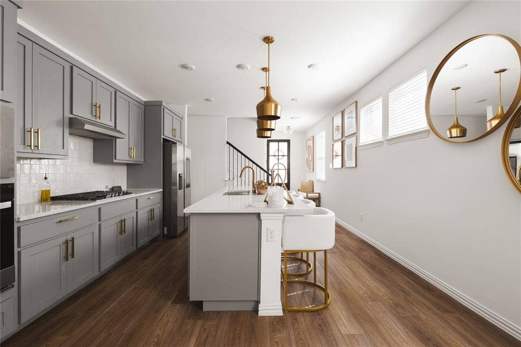 1456 Martingale Lane, Forney, TX 75126 Kitchen featuring grey Shaker-style cabinetry, a central island with a quartz countertop, wood-finish flooring, brass-tone pendant lighting, and a white subway tile backsplash