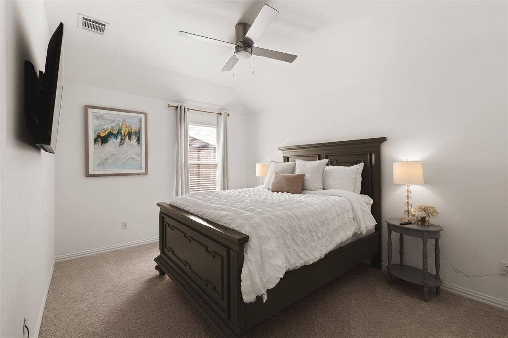1456 Martingale Lane, Forney, TX 75126 Bedroom featuring a high vaulted ceiling, neutral wall-to-wall carpeting, and a multi-blade ceiling fan with integrated lighting