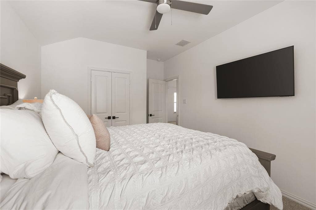 1456 Martingale Lane, Forney, TX 75126 Vaulted ceilings, neutral walls, flush-mount ceiling fan with integrated lighting, and white interior doors with matte black hardware