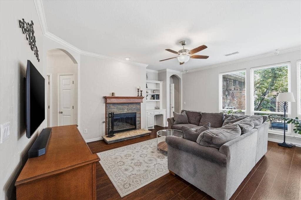 Custom fireplace with desk and bookshelf, open to kitchen and view to back yard - lots of storage in this home