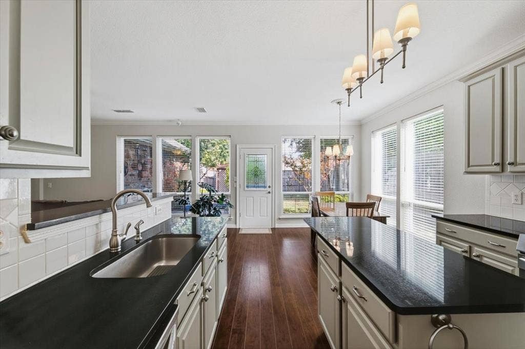 Beautiful granite - painted cabinets - pantry - decorative lighting - door to back yard