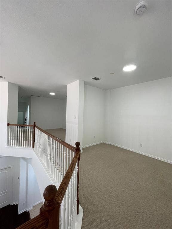 1944 Loma Linda Drive, Irving, TX 75063 Upper-level landing featuring carpeted flooring and a staircase with a wooden handrail and balusters